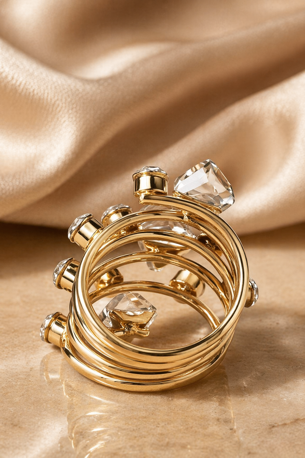 Gold ring with crystal stones on a beige fabric background