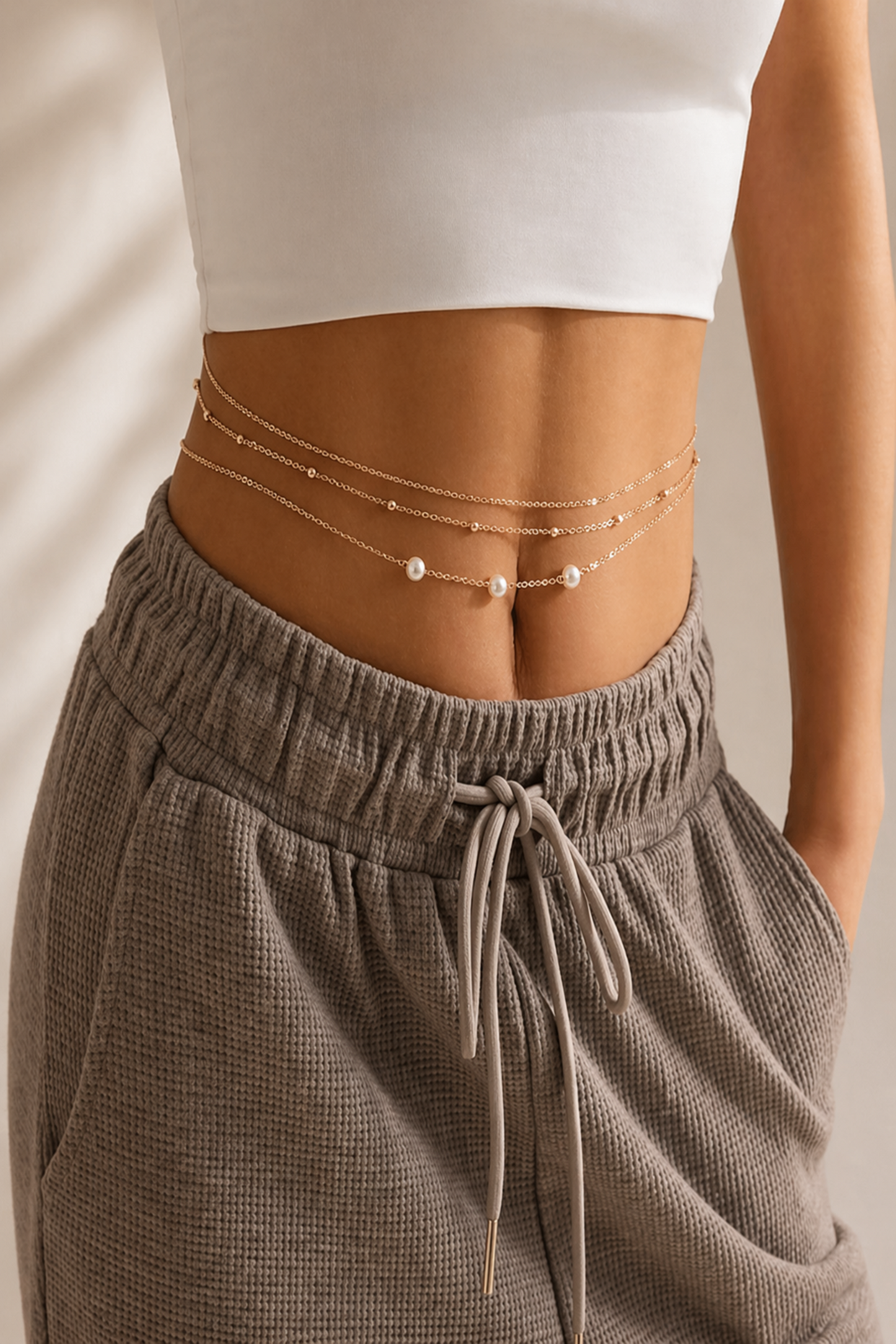 triple strand waist chain laid on neutral surface