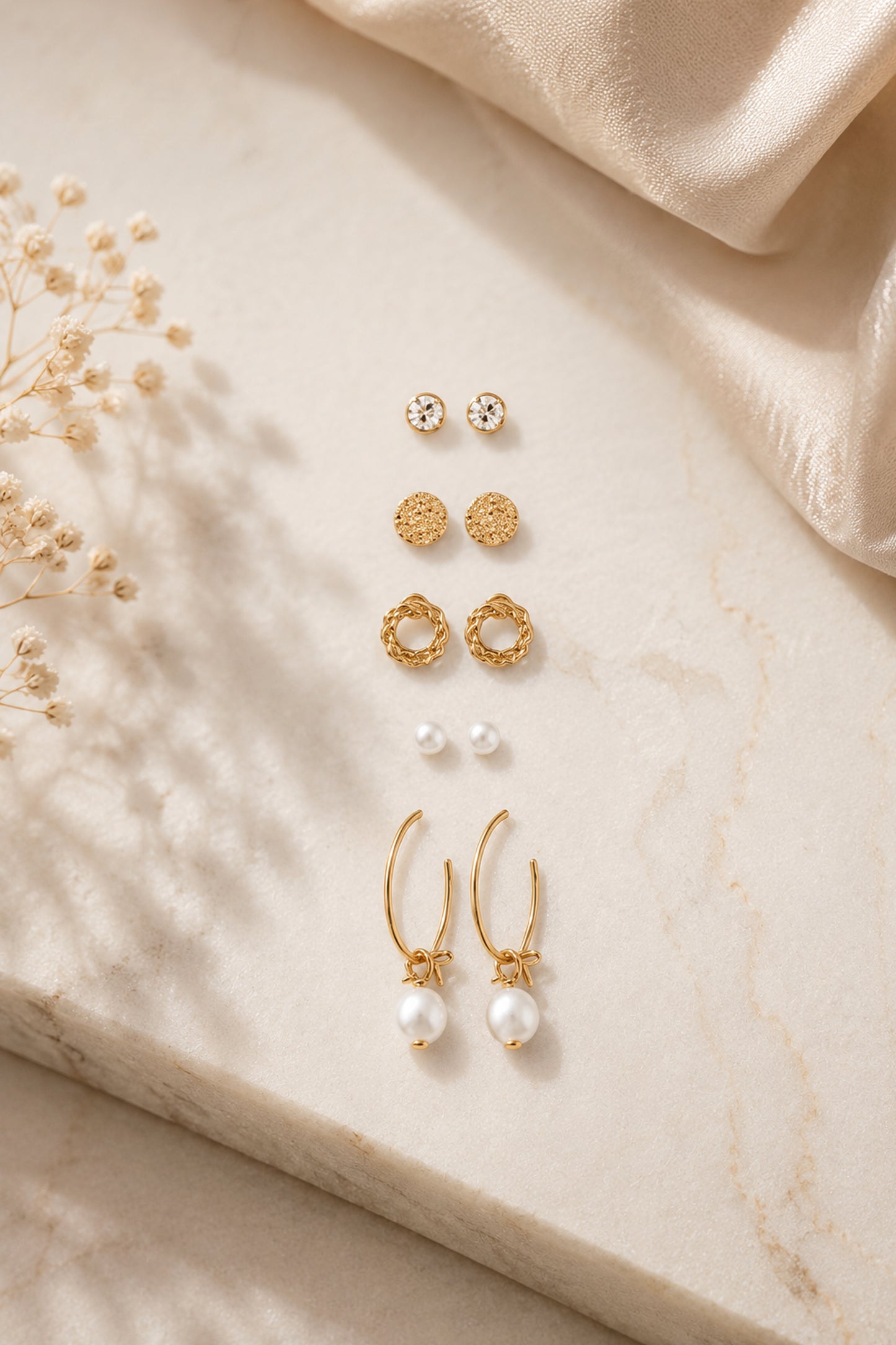 Mixed stud earrings with clear stones, pink accents and polished forms