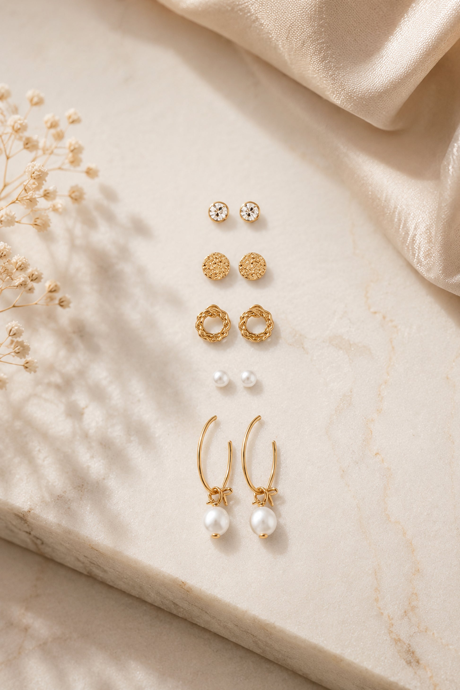 Mixed stud earrings with clear stones, pink accents and polished forms