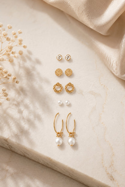 Mixed stud earrings with clear stones, pink accents and polished forms