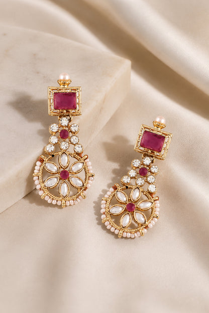 Matching drop earrings with framed red stones, clear accents and white petal details