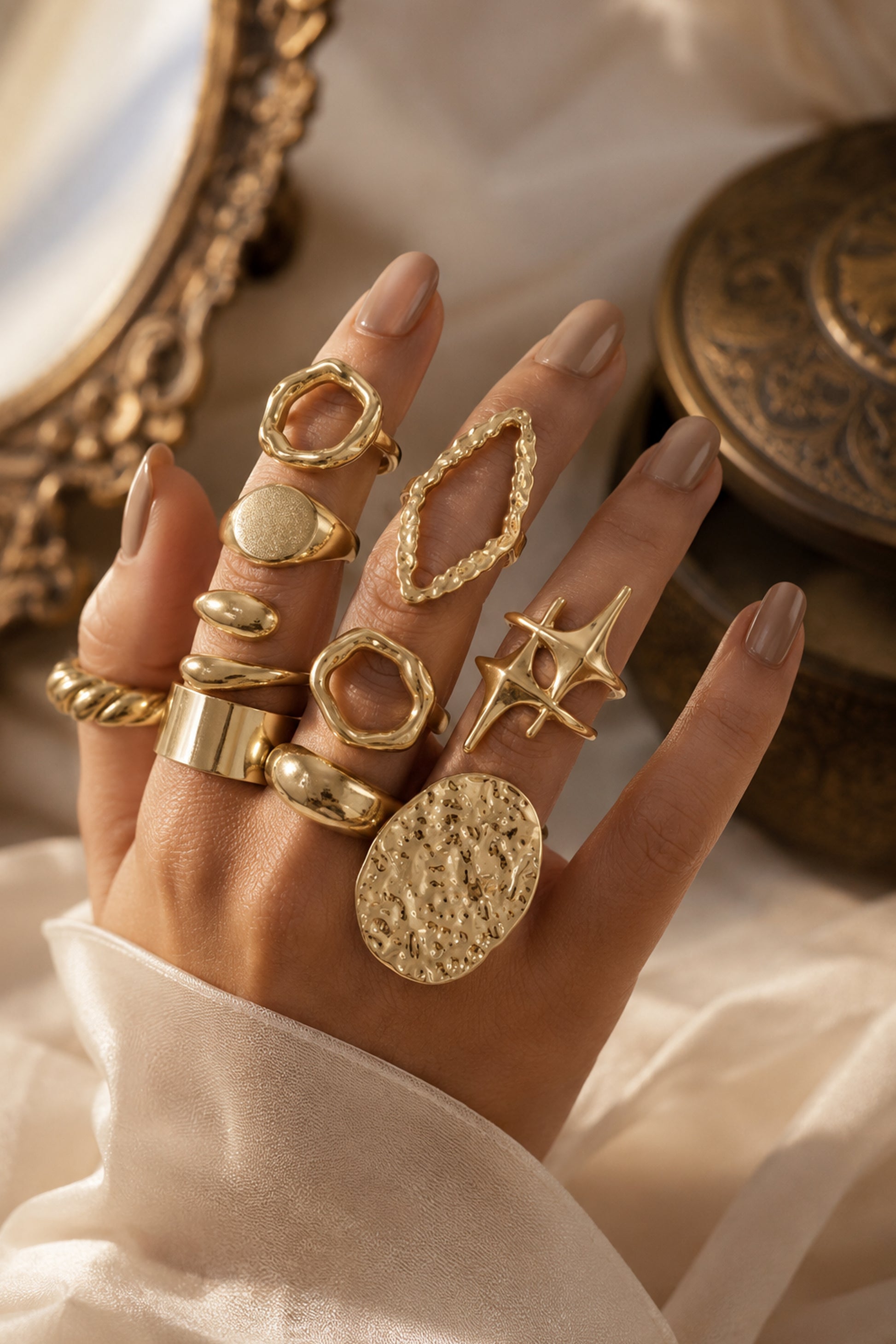 Ten gold-tone rings displayed under warm directional light