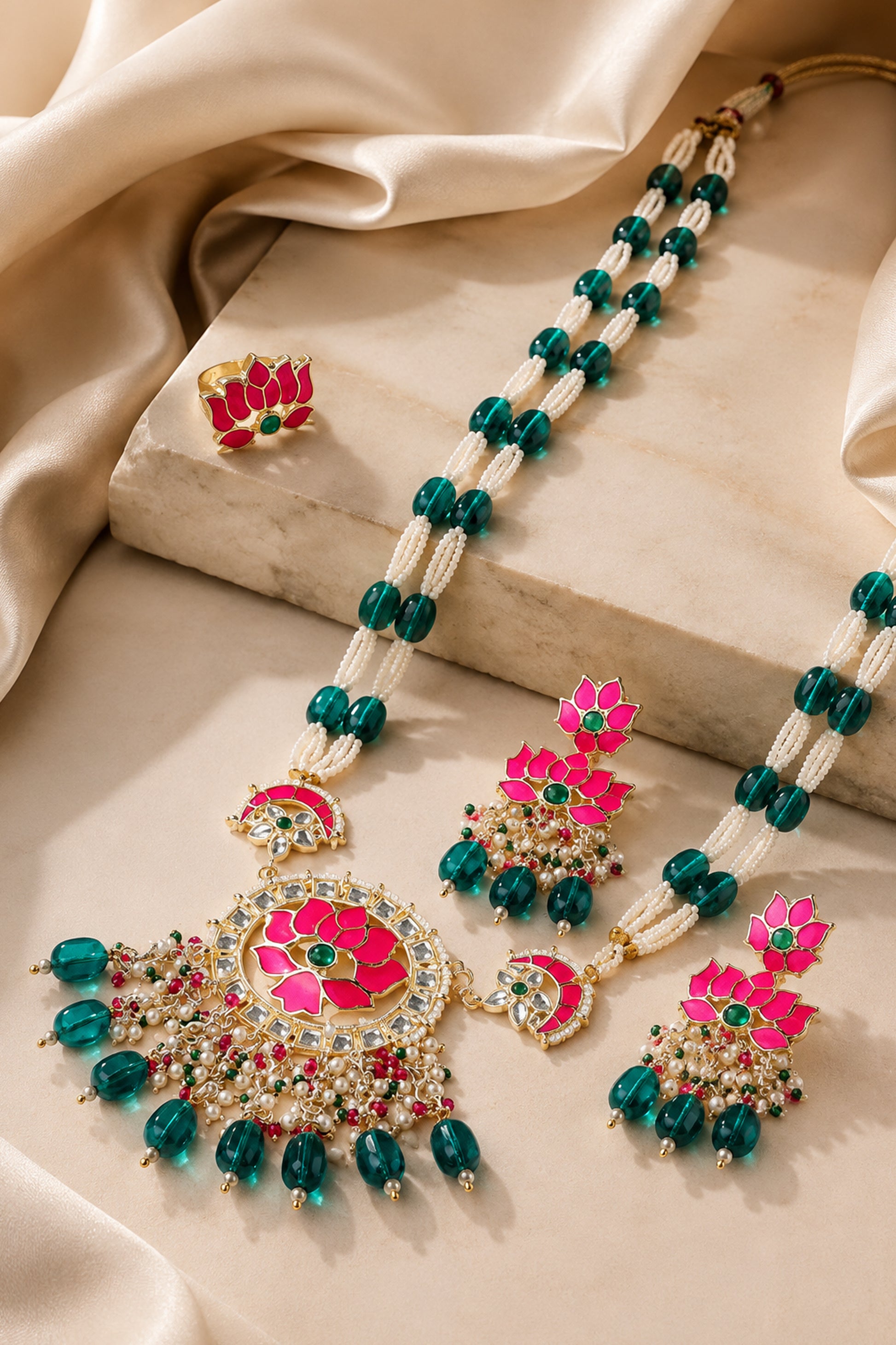 Lotus jewelry set displayed with matching necklace, earrings and statement ring