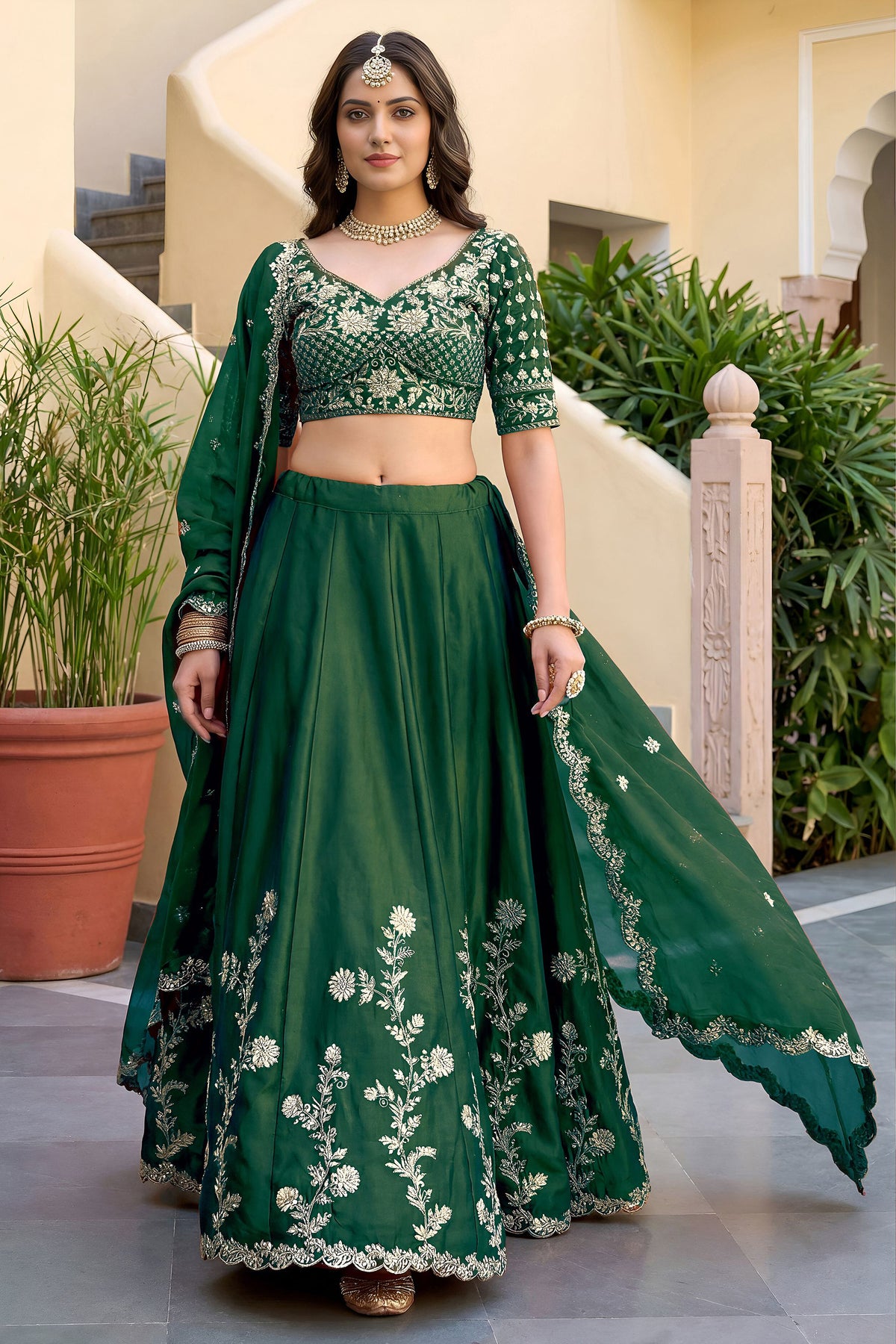 Full-length view of green embroidered lehenga and blouse