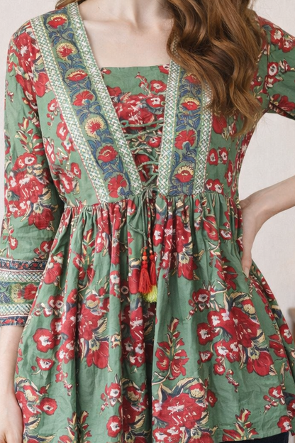 Close-up neckline detail of green printed women top