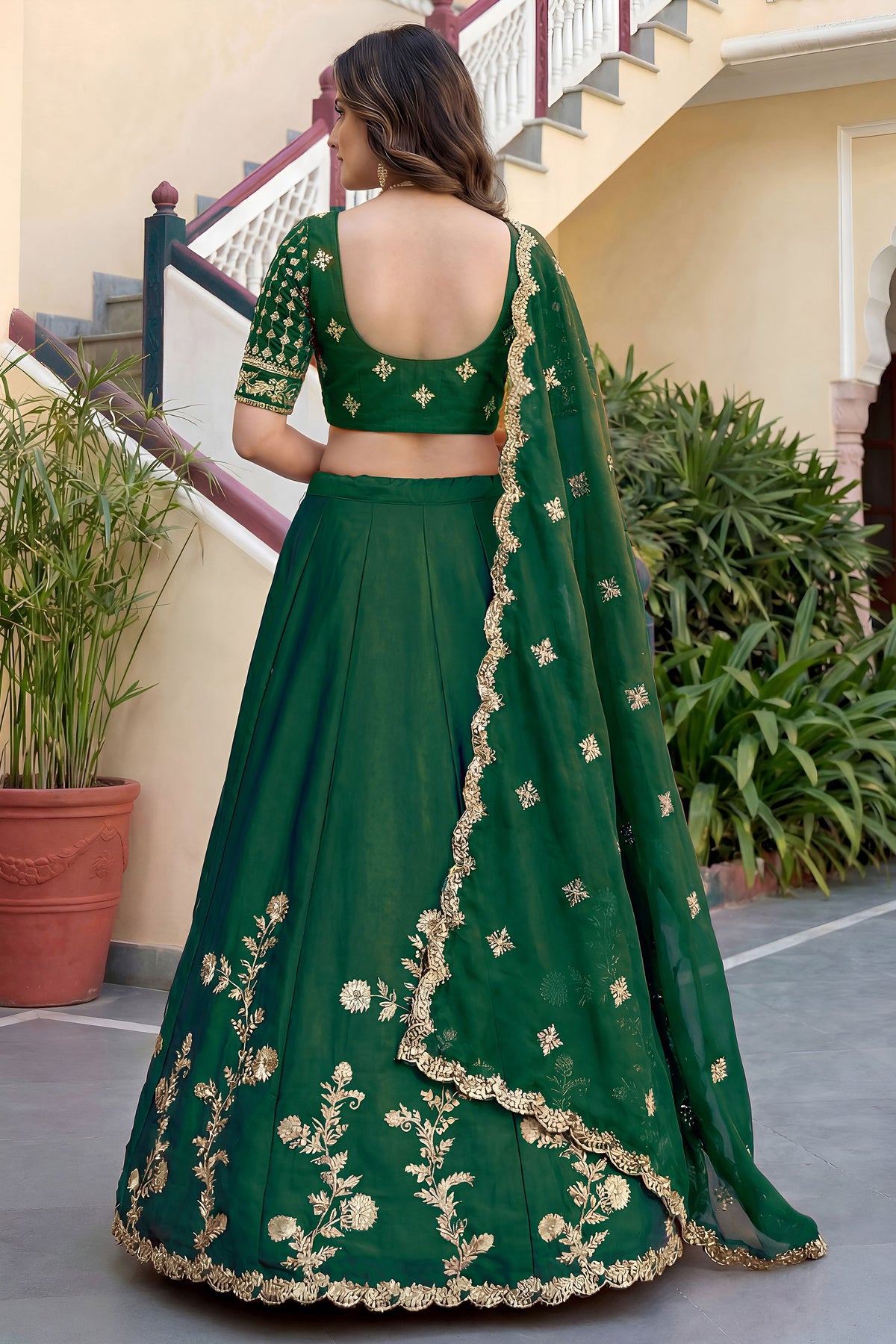 Back side view of green lengha choli suit with detailed embroidery