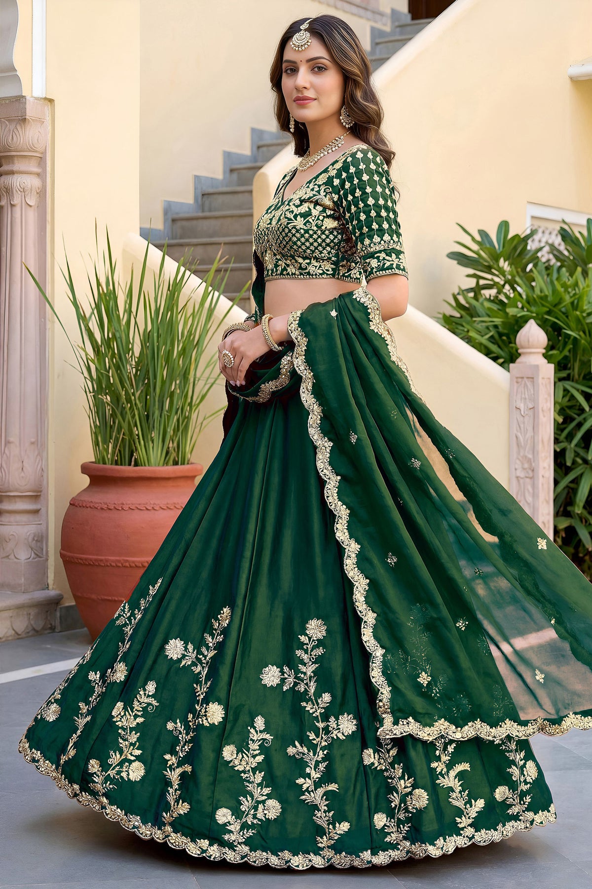 Side view of green lengha choli suit with detailed embroidery