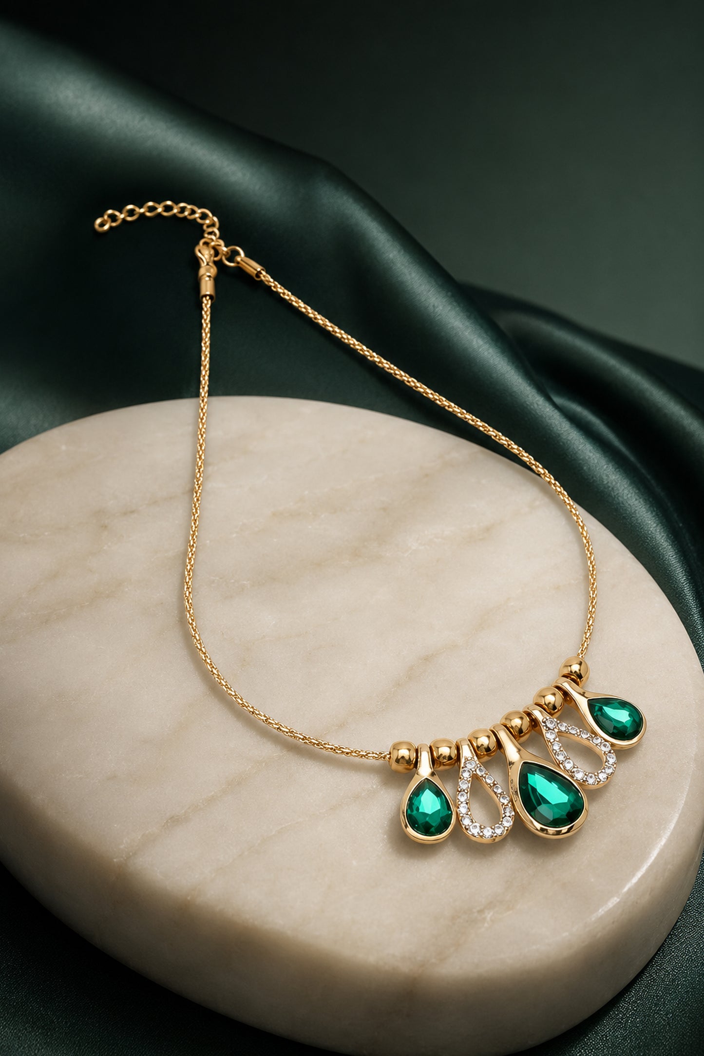 Gold-tone necklace with green faceted and clear accents