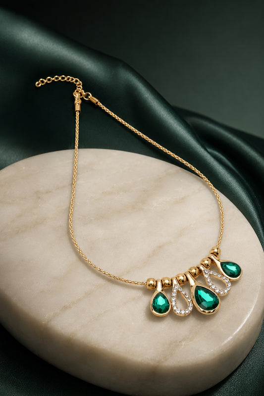 Gold-tone necklace with green faceted and clear accents