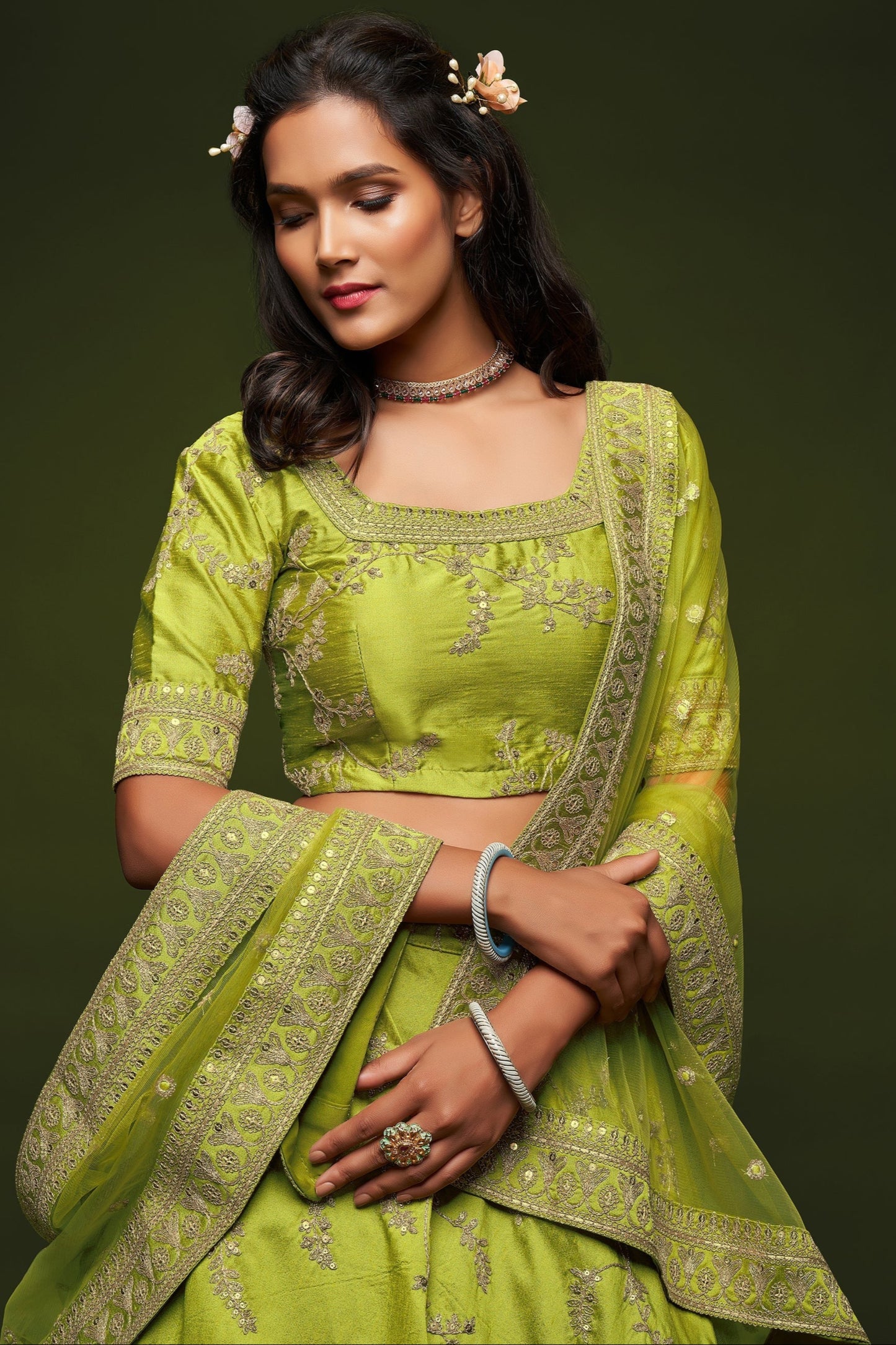 close up of sequins work on green art silk lehenga fabric