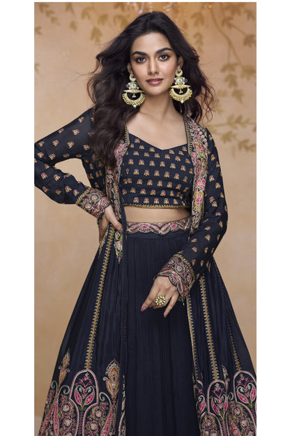 Close-up of black designer Anarkali gown with ornate embroidery, matching crop top, and full-length embellished jacket