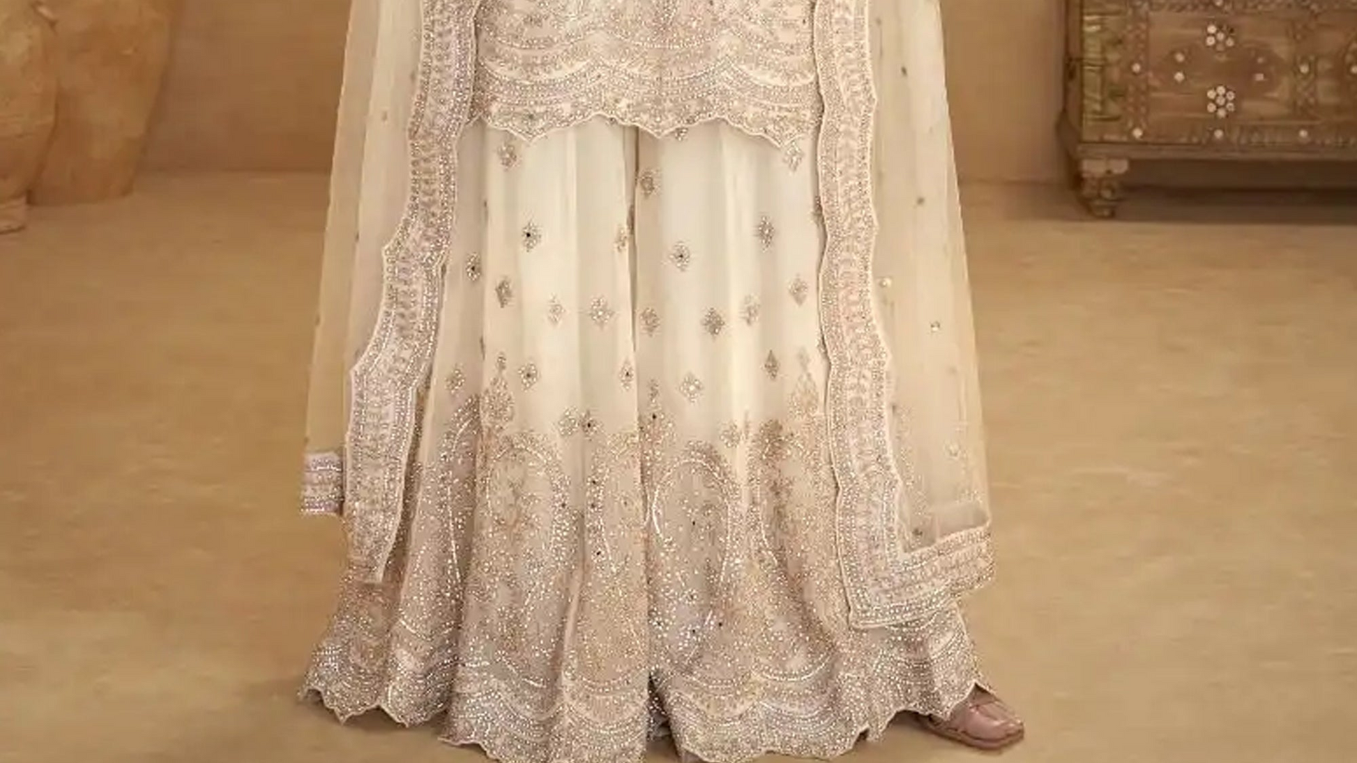 Close-up of hand work embroidery on beige palazzo fabric