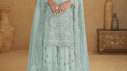 Embroidery craftsmanship close-up on mint blue net fabric