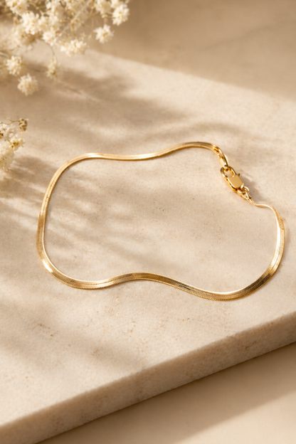 gold herringbone anklet on ankle
