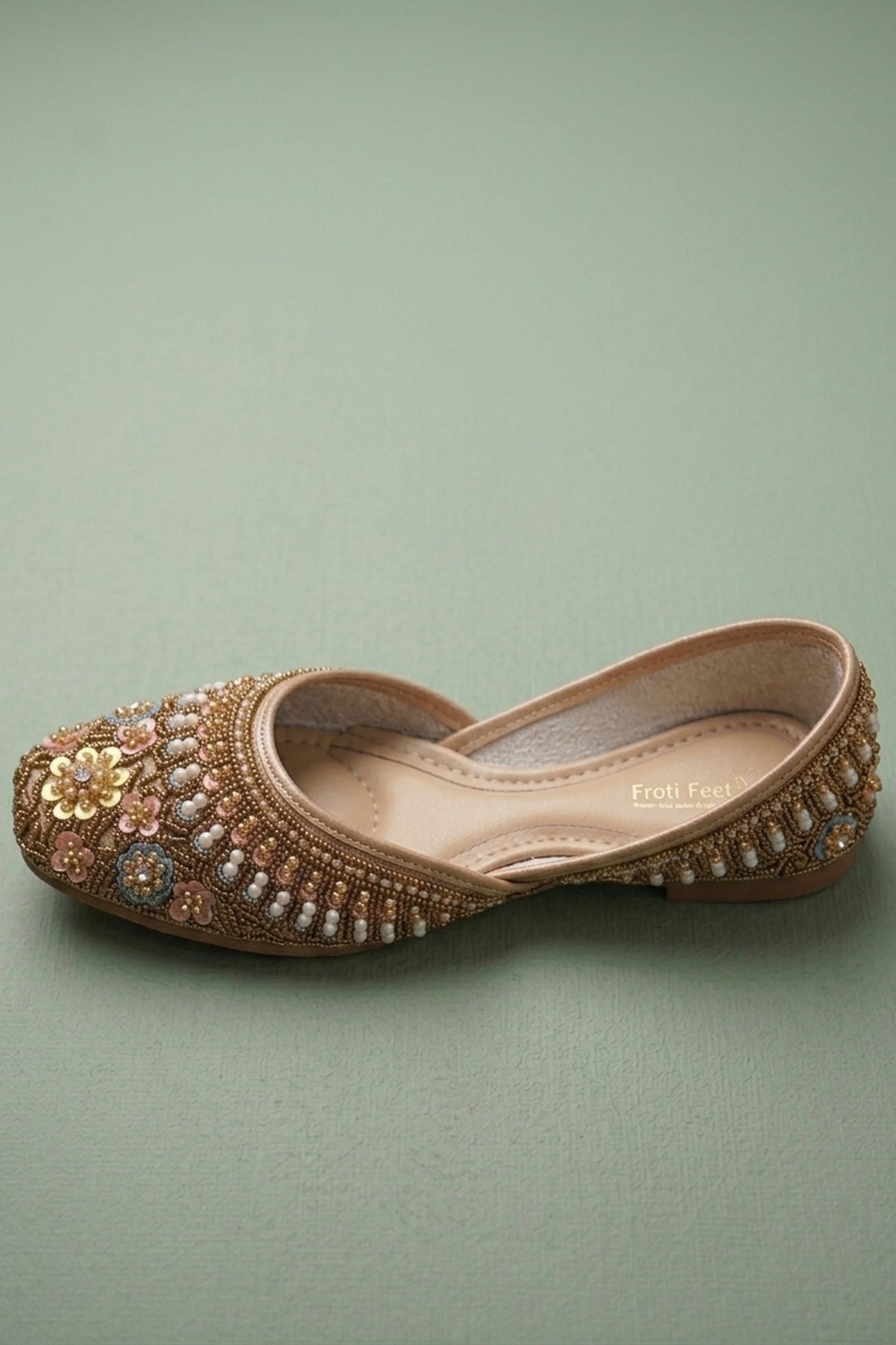 Top view of embellished gold ethnic slip-on shoes for women
