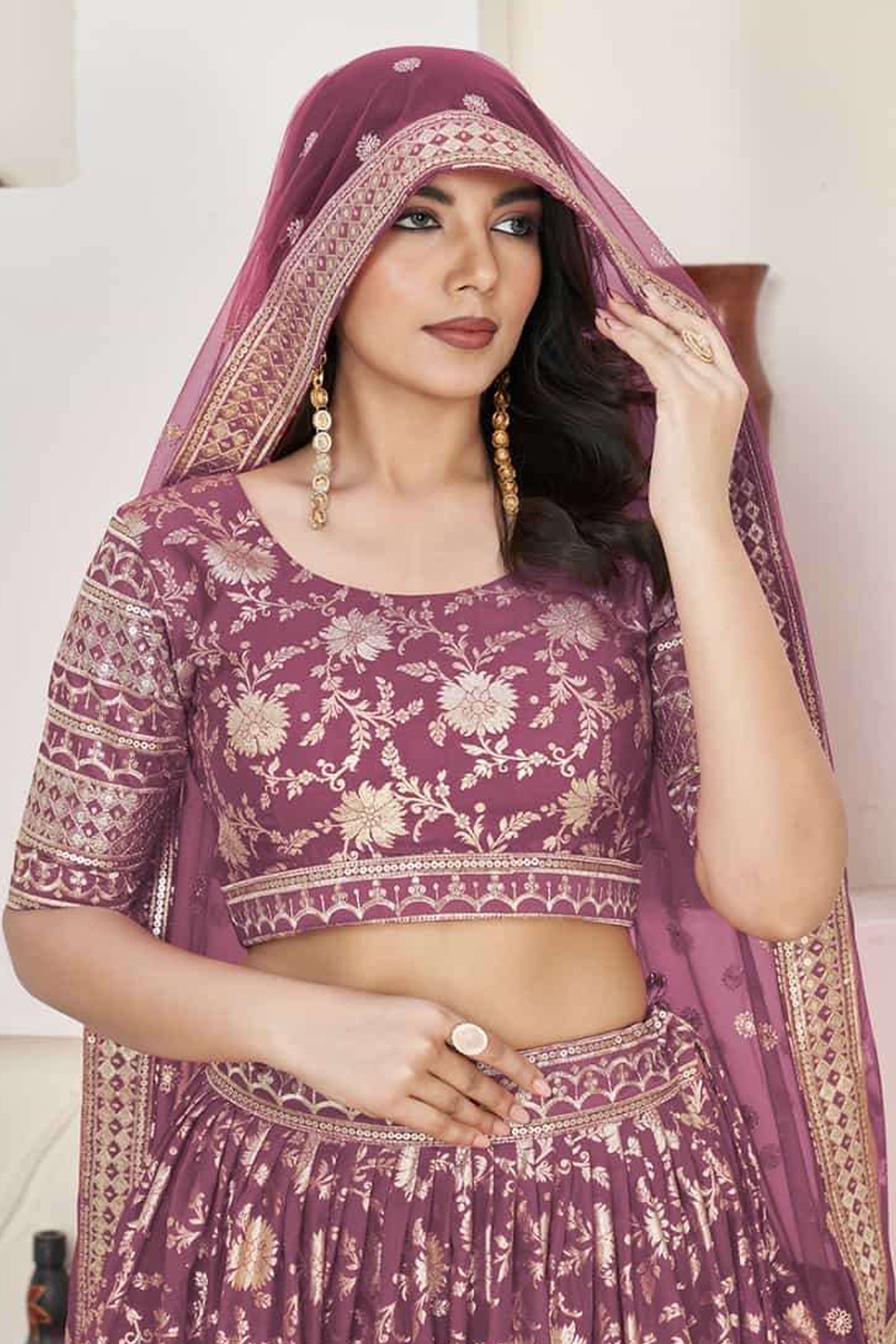 Close-up of sequins butti work on rose gold net fabric