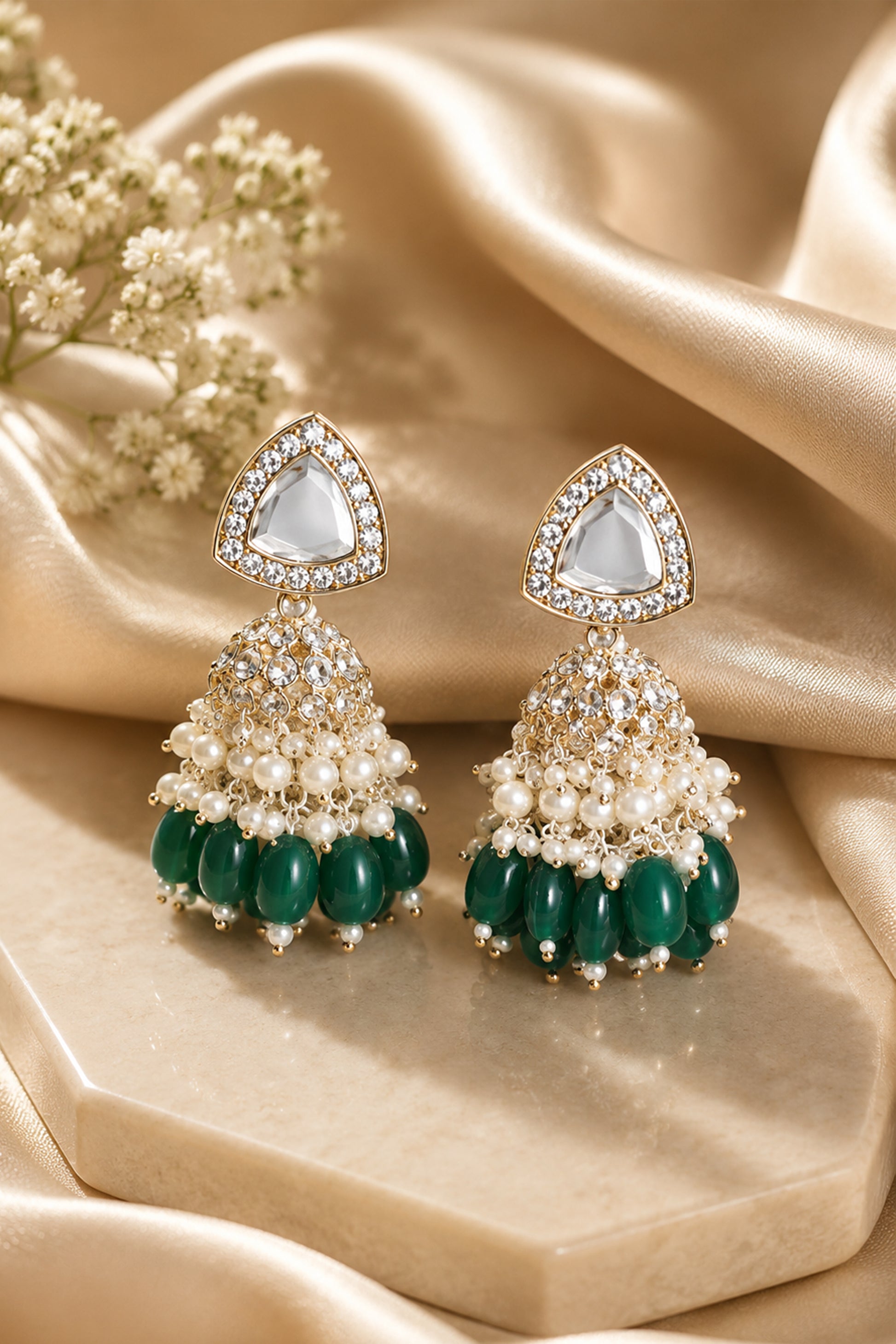 Close-up of triangular clear-stone top and layered jhumka dome