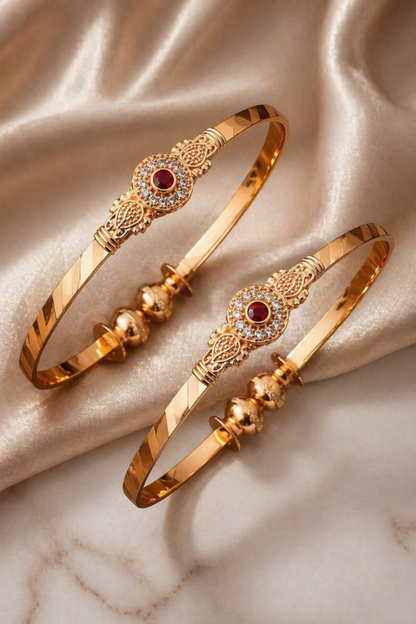 close-up of knot design gold bangle with clear stones