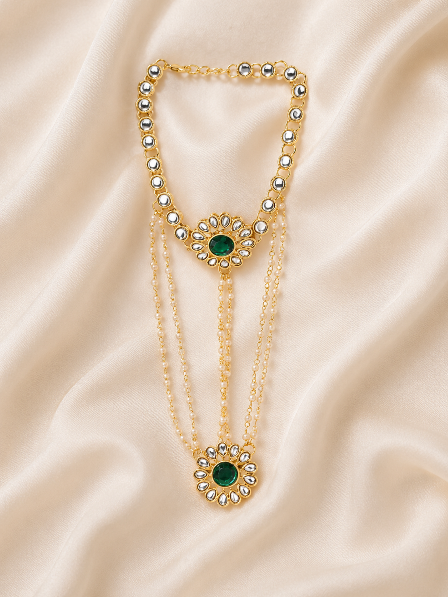 detailed kundan hand harness bracelet on soft fabric