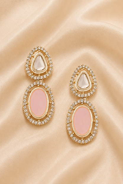 Pink and reflective stone jewelry arranged on cream satin