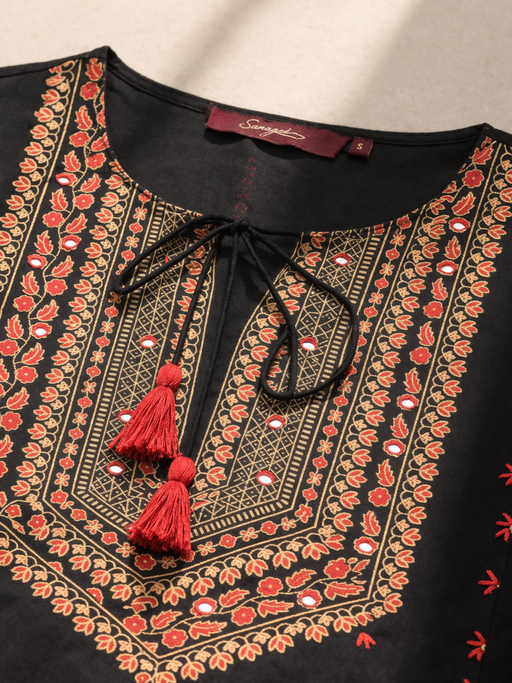 close-up hemline detail of black viscose kurti