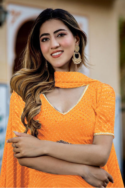 Close-up of laheriya print work on orange lehenga