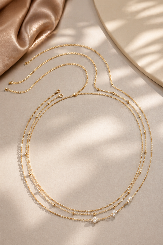 layered gold tone waist chain with pearl accents