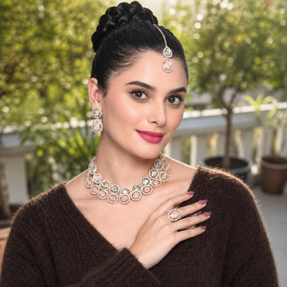 Gold-tone jewelry set with pink oval stones and matching earrings