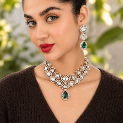 Gold-tone necklace with framed clear stones and green drop pendant