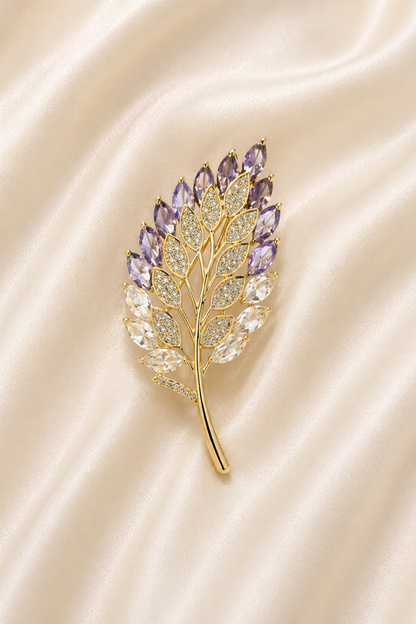 gold tone leaf brooch pin with purple and clear stones