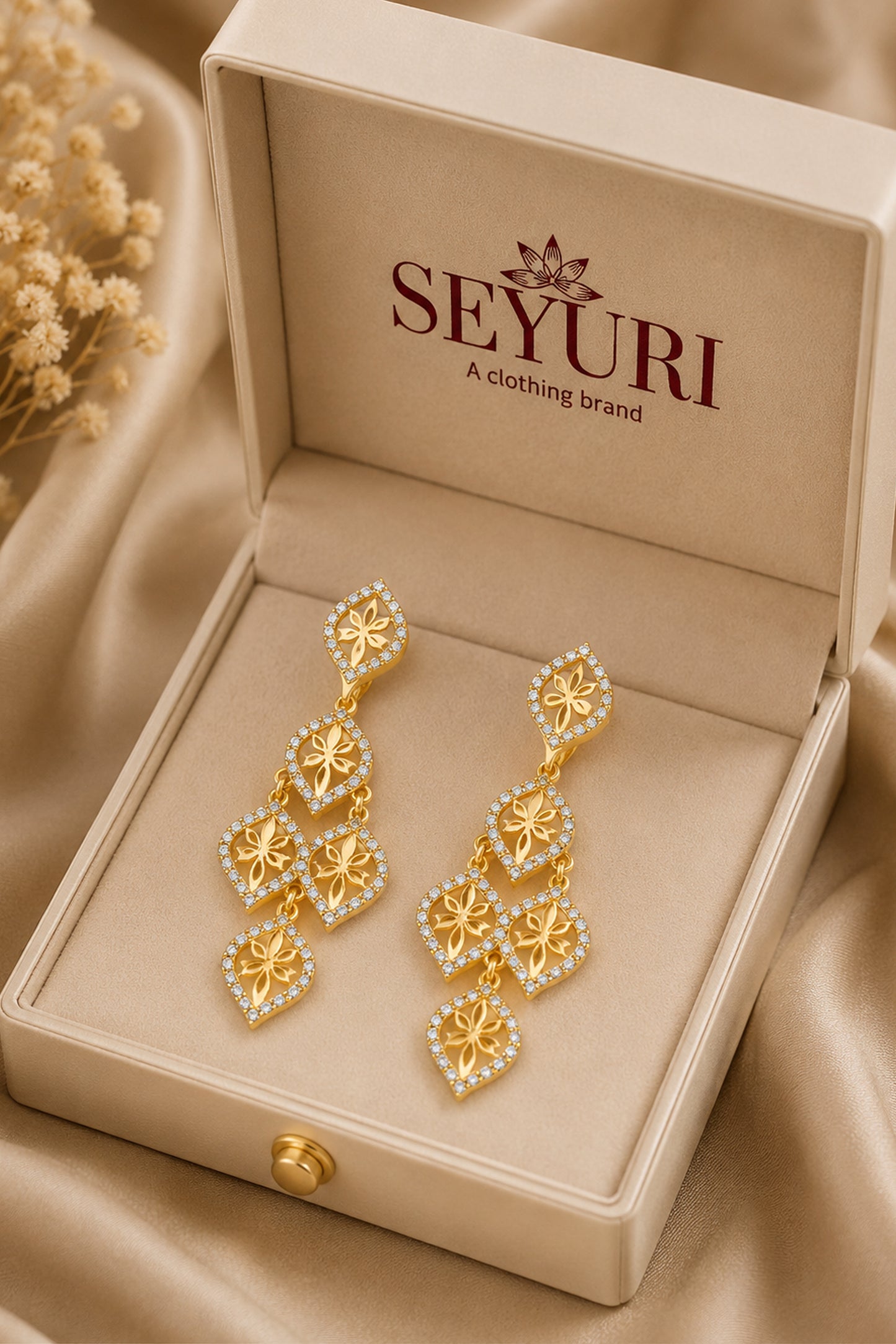 Gold-tone earrings featuring sculpted leaf details