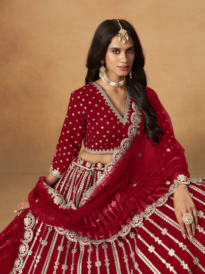 Close-up of heavy embroidery work on dark red lehenga fabric