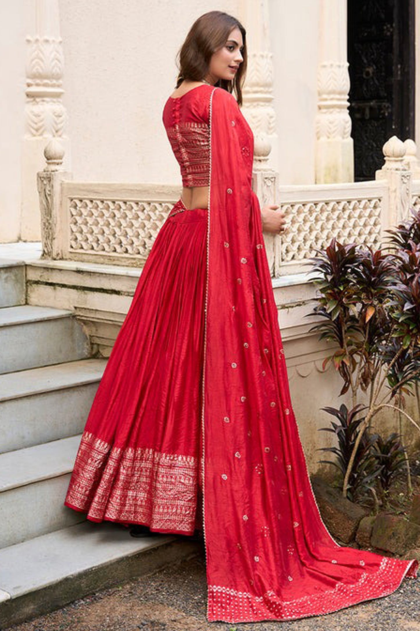 Side angle of red lehenga choli with woven design