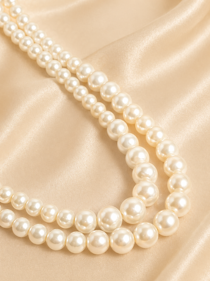 Pearl necklace on a beige satin background