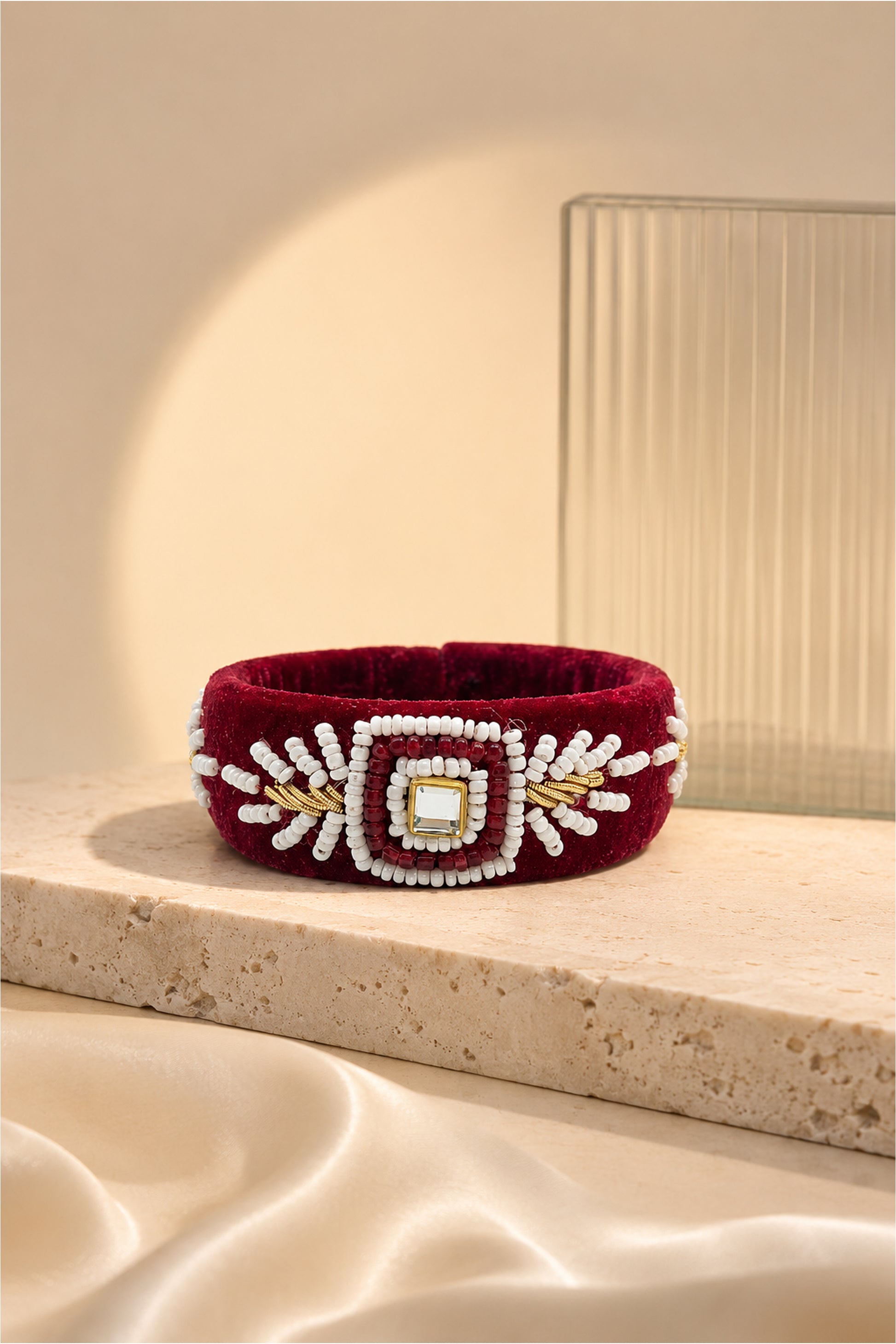 Maroon bangle with white bead motifs and square reflective centre