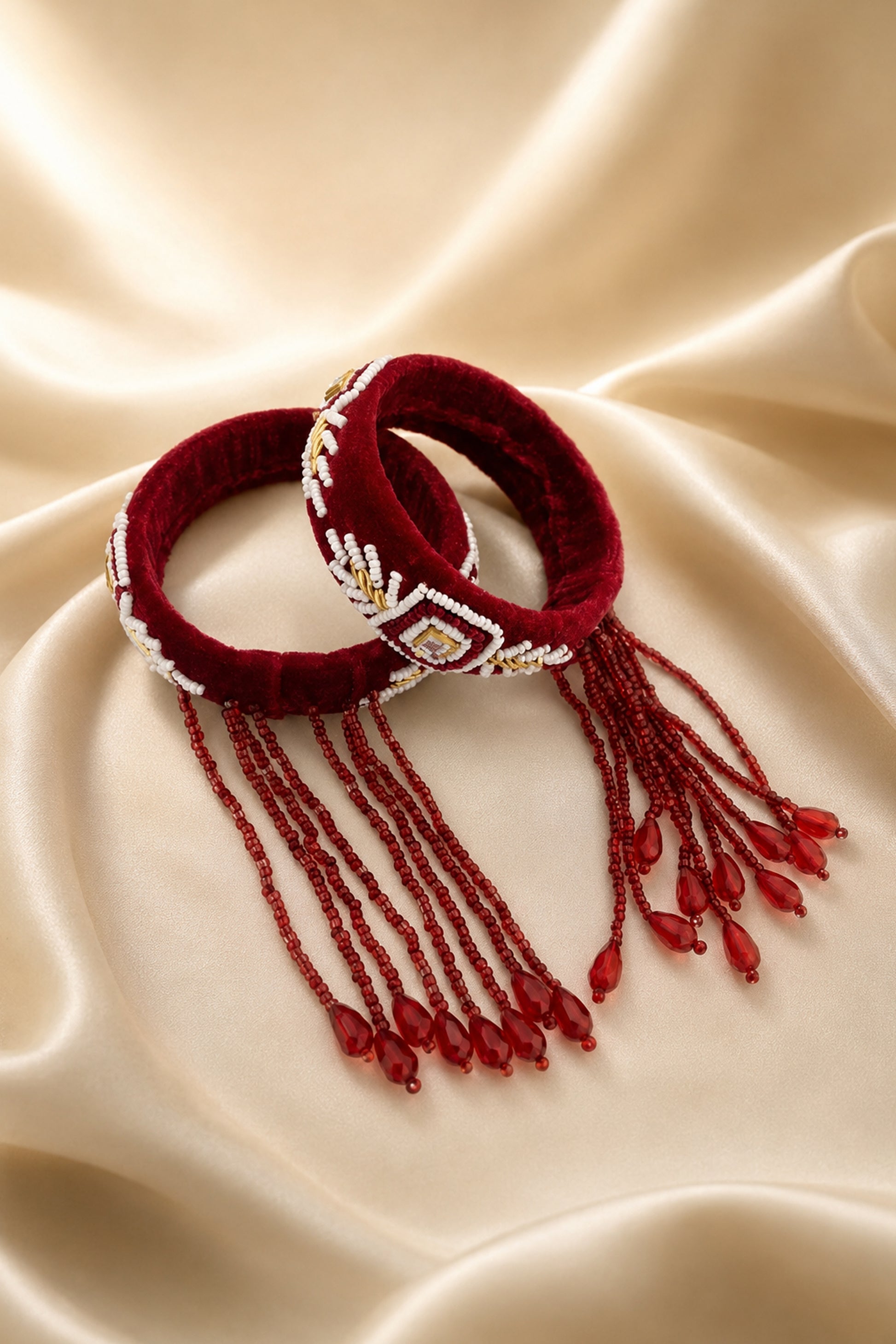Front view of the openable bangle pair on an ivory display stand