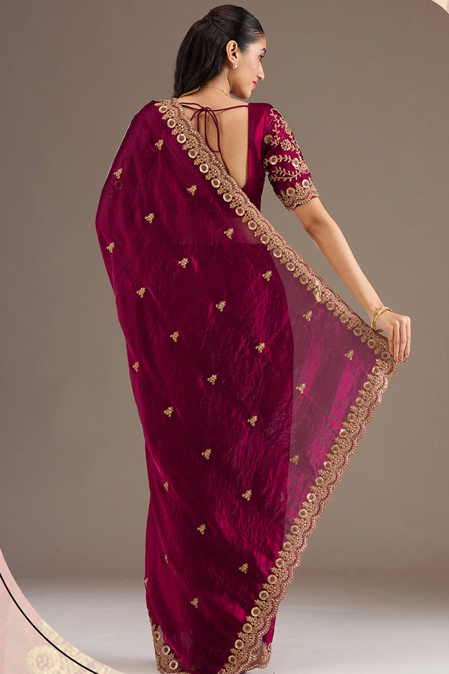 Woman wearing Burgundy Red Saree at reception event