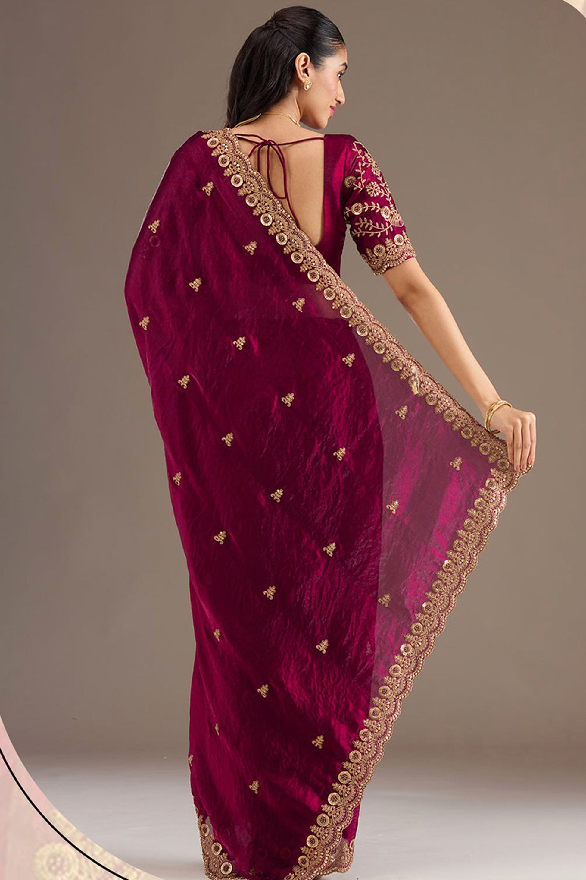Woman wearing Burgundy Red Saree at reception event
