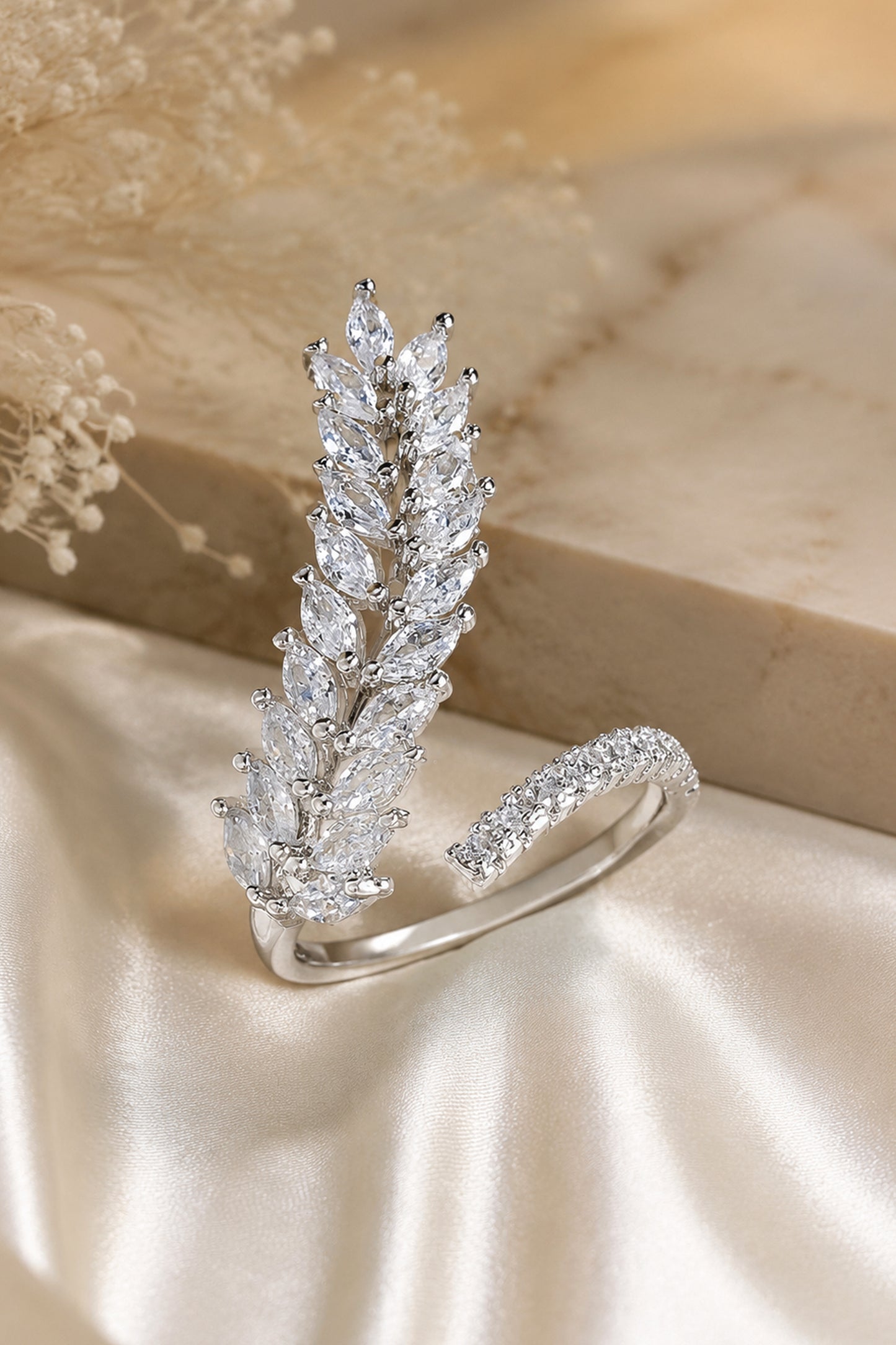 marquise stone ring with layered leaf design on satin background