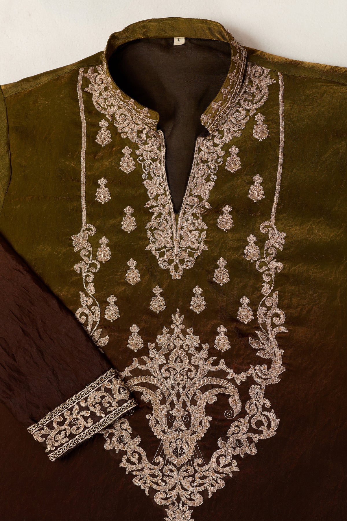 Detail view of embroidered work on the mehndi green kurta
