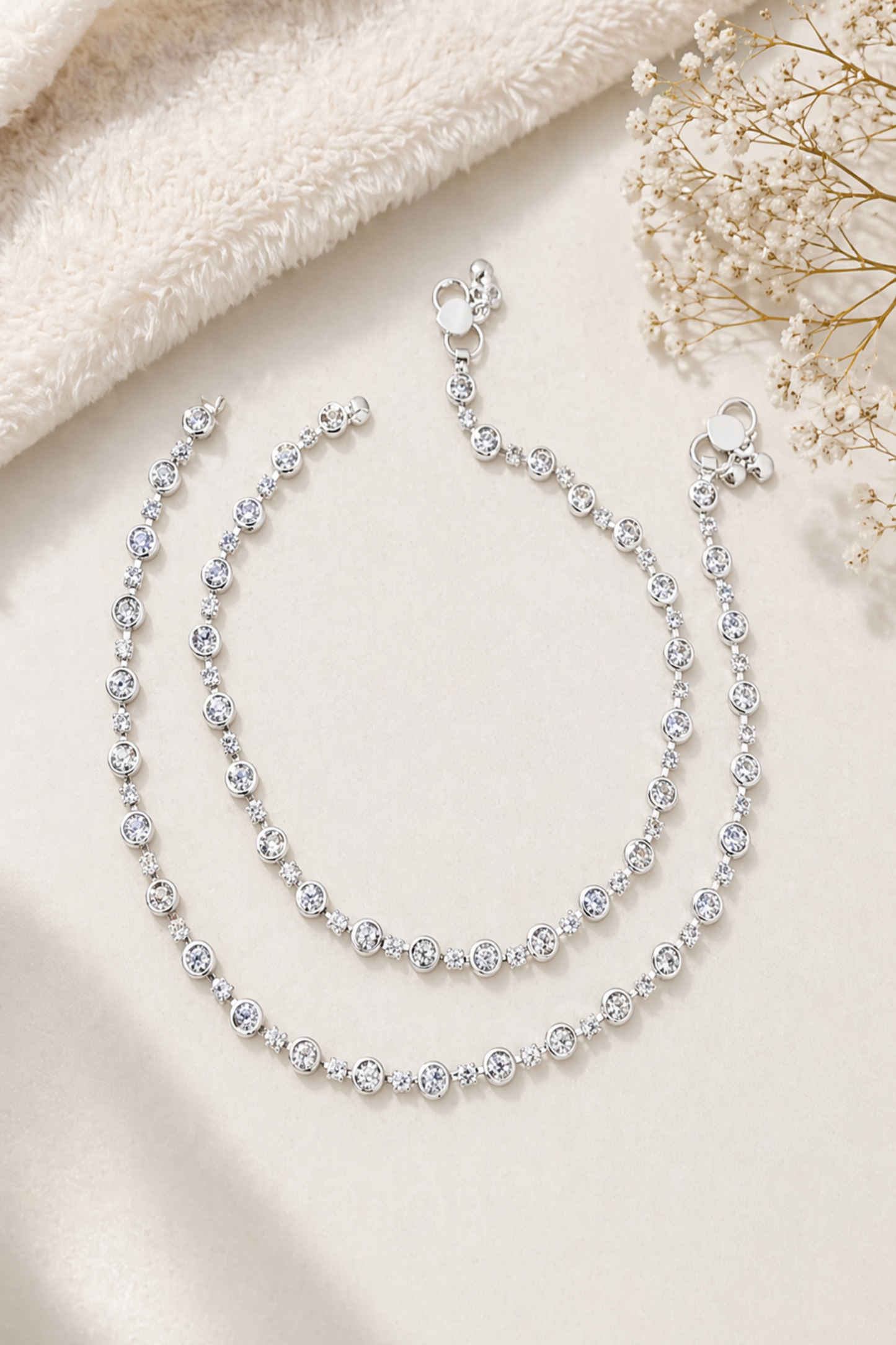 minimal anklet displayed on neutral cushion surface