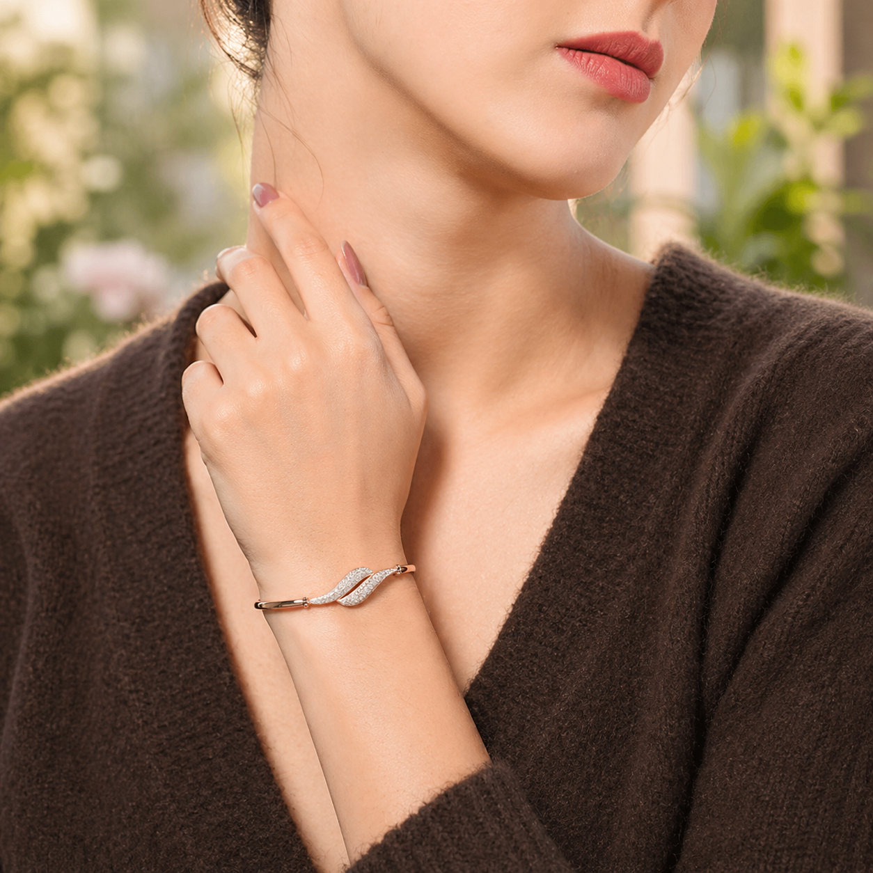 close-up of curved leaf detail bracelet on soft fabric