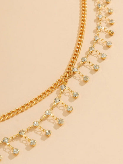 layered gold waist chain on model with white outfit