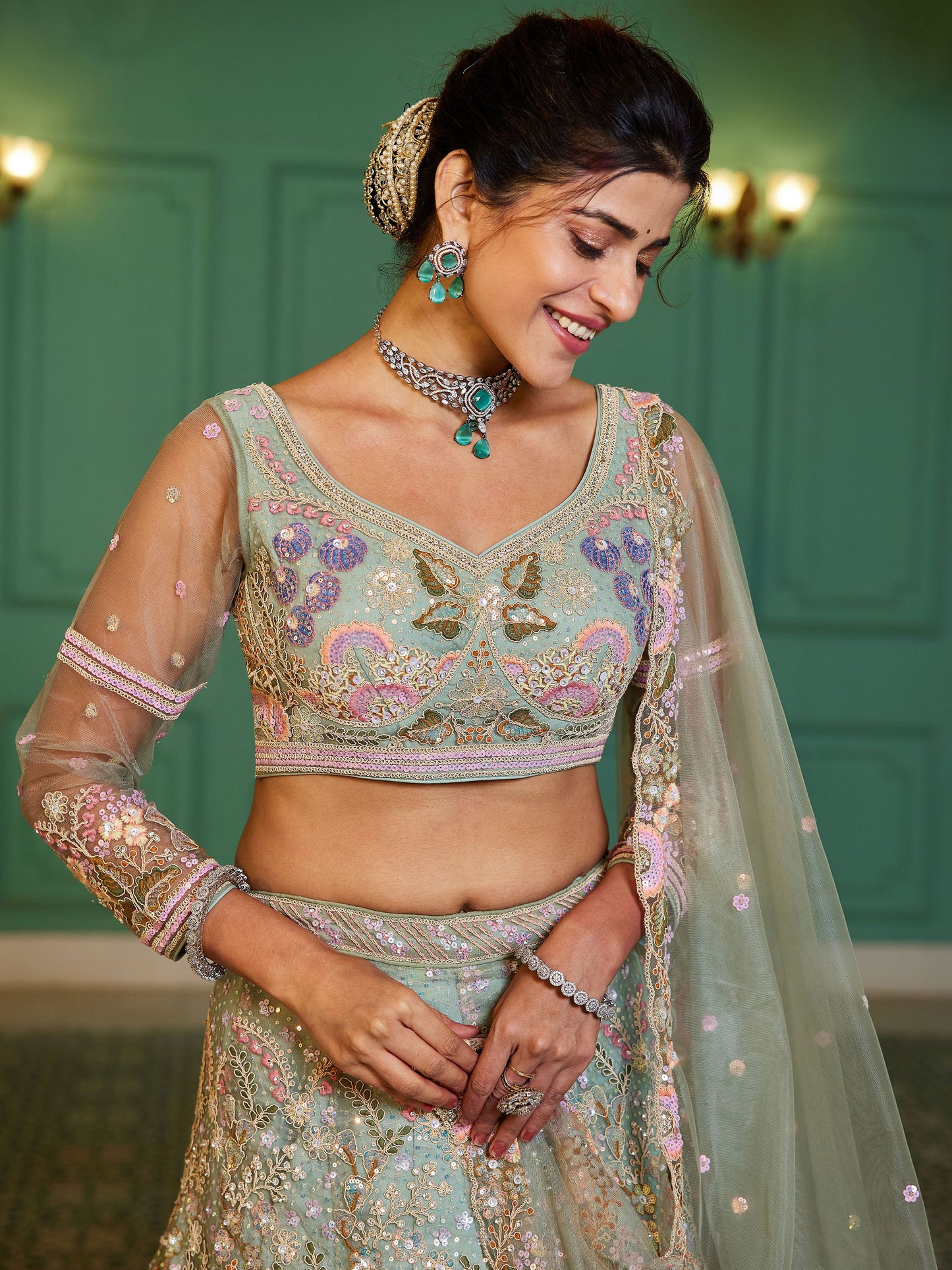 Close-up of sequins and thread work on green lehenga choli