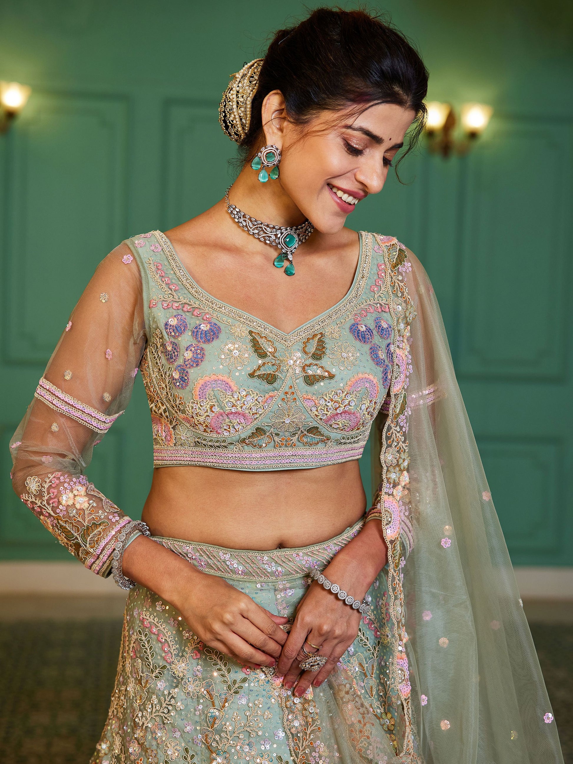 Close-up of sequins and thread work on green lehenga choli