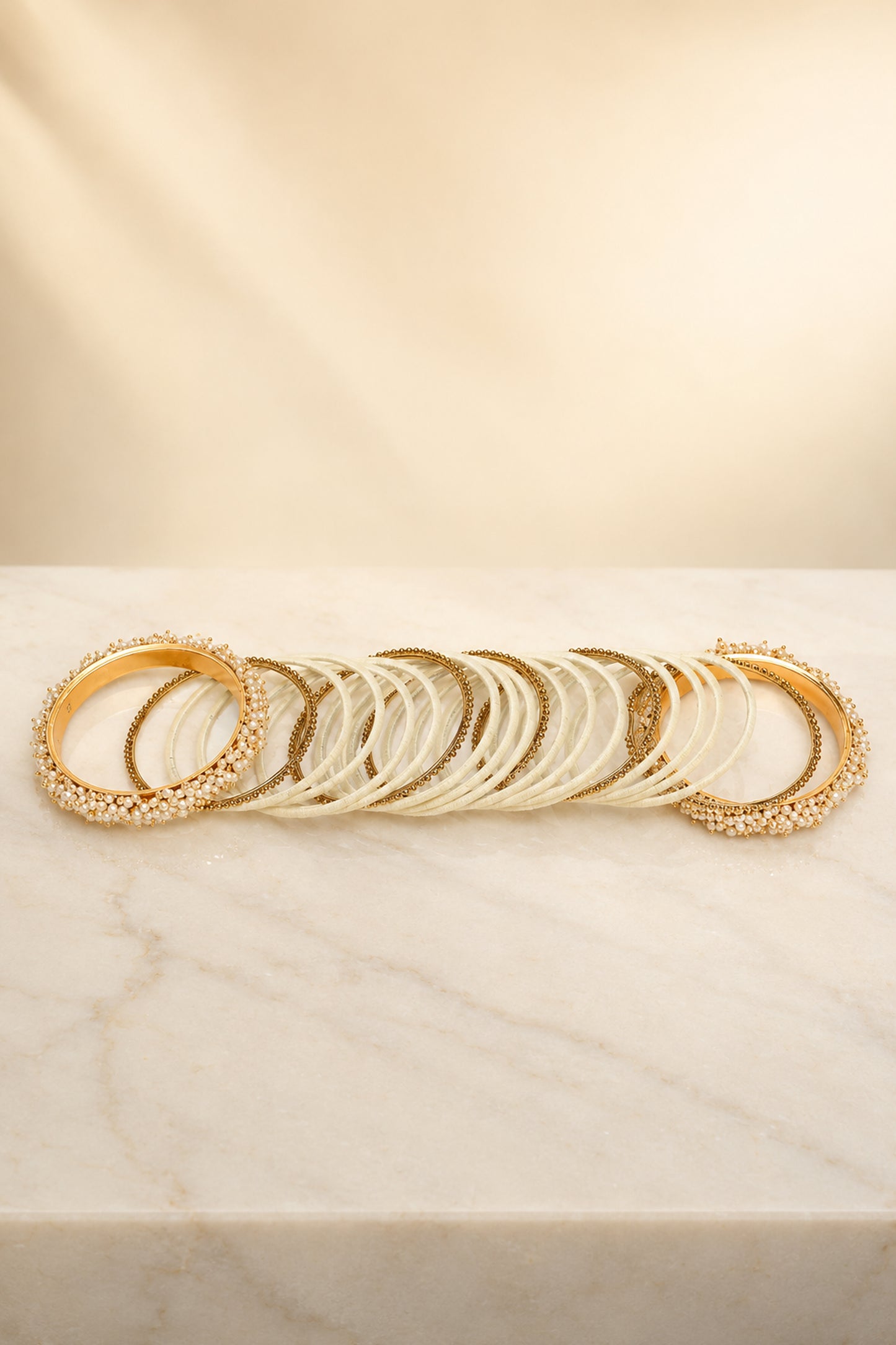 Stacked fashion jewellery bangles with mixed-width profile