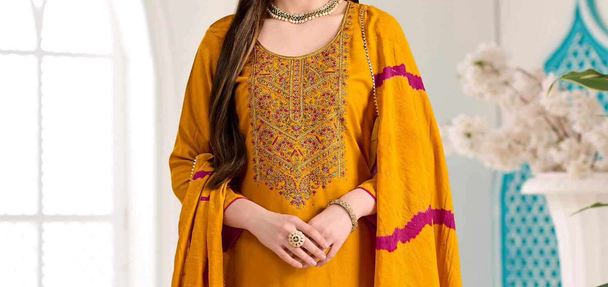 Woman wearing mustard Golden yellow viscose salwar kameez with embroidery work