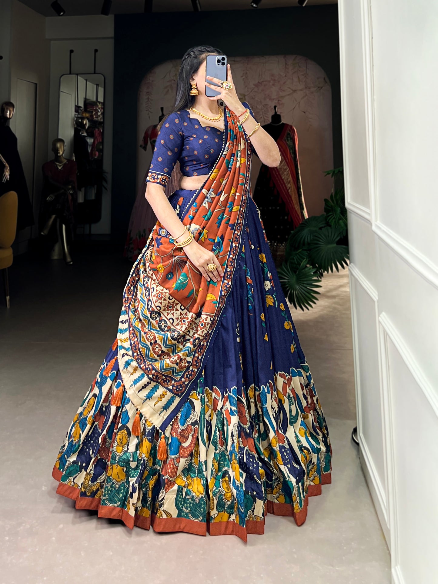 Side profile of royal blue lehenga with artistic motifs