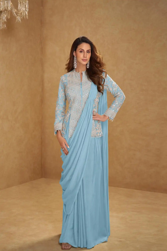 Woman wearing a light blue saree with a matching blouse against a beige background